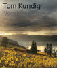Book cover titled Tom Kundig Working Title, showing a lakeside vineyard with yellow leaves, a low rusted-roof building, and a stormy sunset sky.