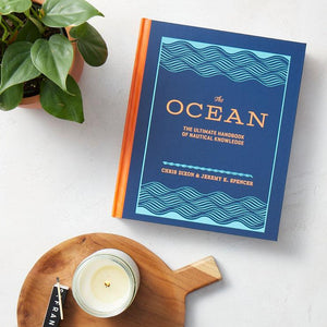 The Ocean: The Ultimate Handbook of Nautical Knowledge with plant and candle