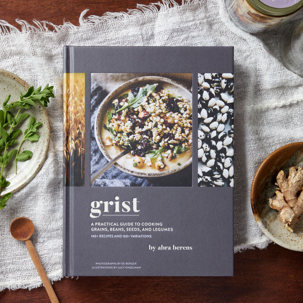 Grist with table linens, herbs, stoneware and wooden spoon