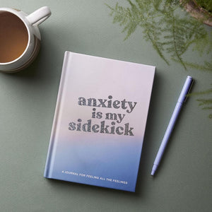 Anxiety Is My Sidekick journal with cup of tea, houseplant and pen
