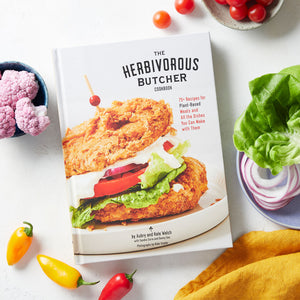 The Herbivorous Butcher Cookbook with dish towel and vegean burger toppingss